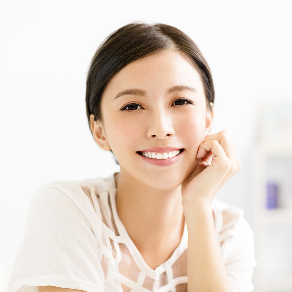 closeup smiling young asian woman face in living room