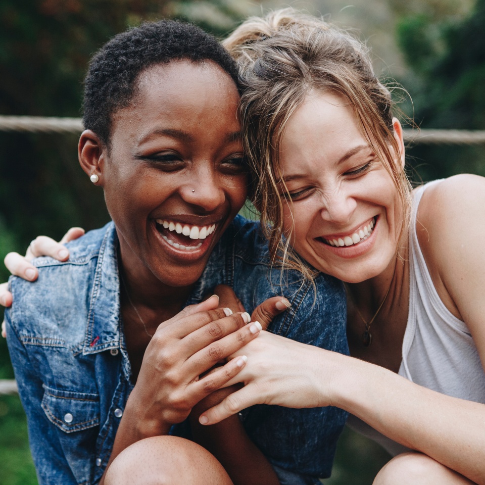 Happy friends holding each other