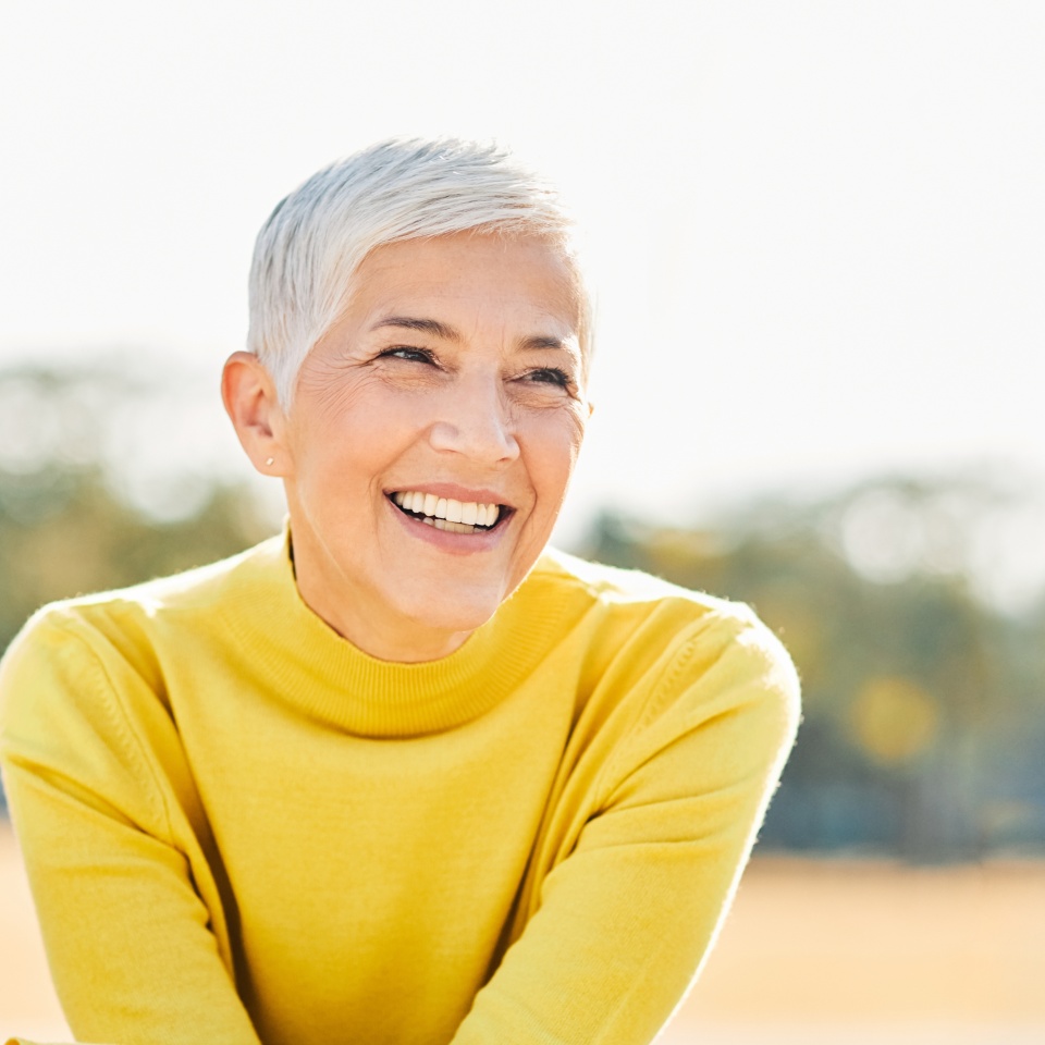 Portrait of an elderly woman outdoors. Happy senior woman in park