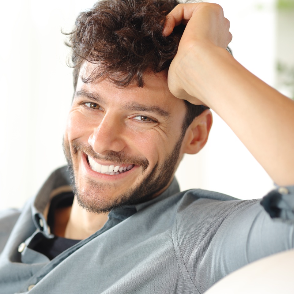 Portrait of a happy man with perfect smile looking at camera at home