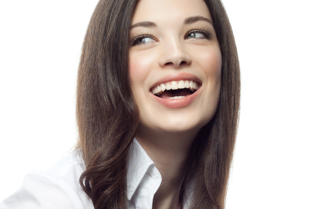 closeup portrait of attractive caucasian smiling woman brunette isolated on white studio shot lips toothy smile face hair head and shoulders tooth